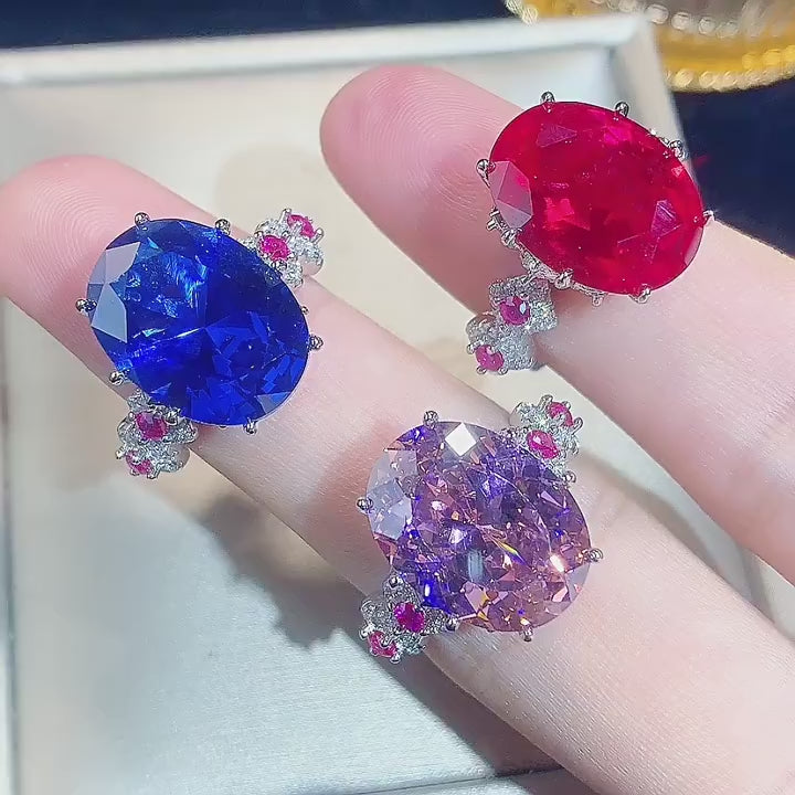 Load video: Urqanyu copper base gold-plated simulated colored gem corundum egg-shaped jump color creative cubic zirconia ring